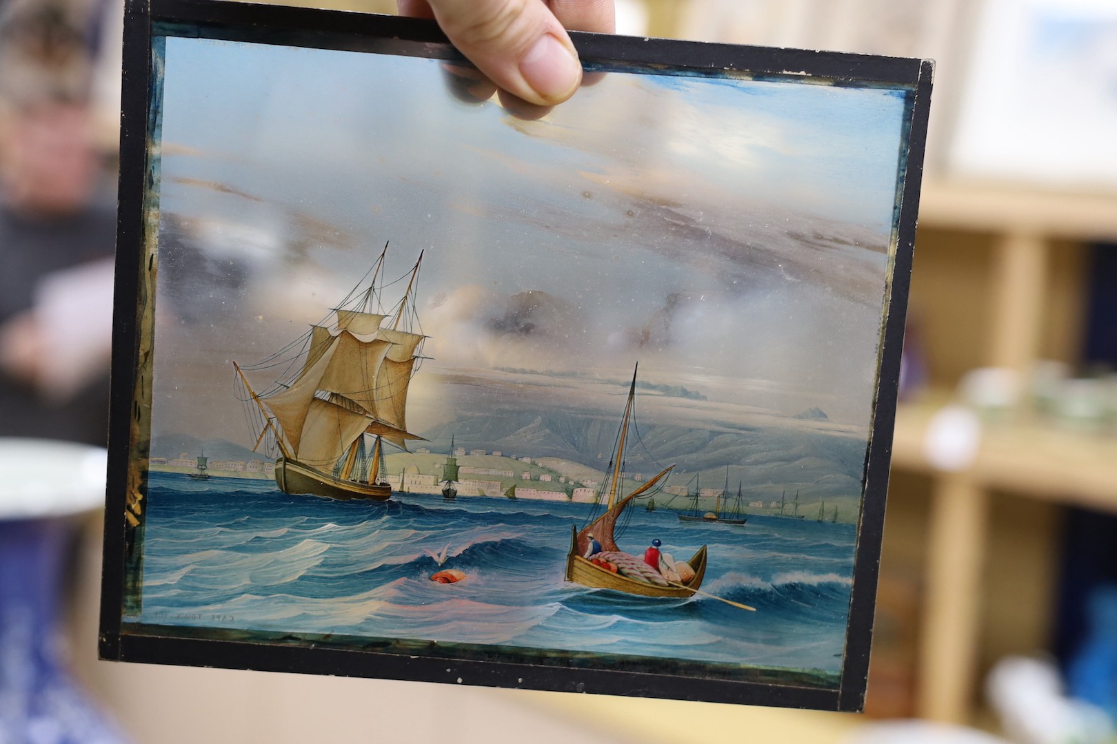 A pair of late 19th century reverse painted glass panels of HMS Victory, possibly large scale lantern slides, 21cms wide x 18 cms high.